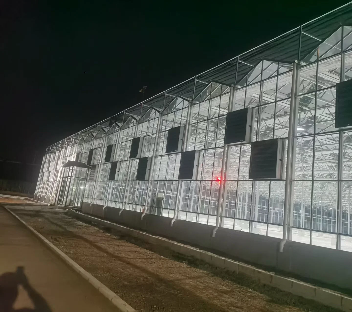 Commercial glass greenhouse at night